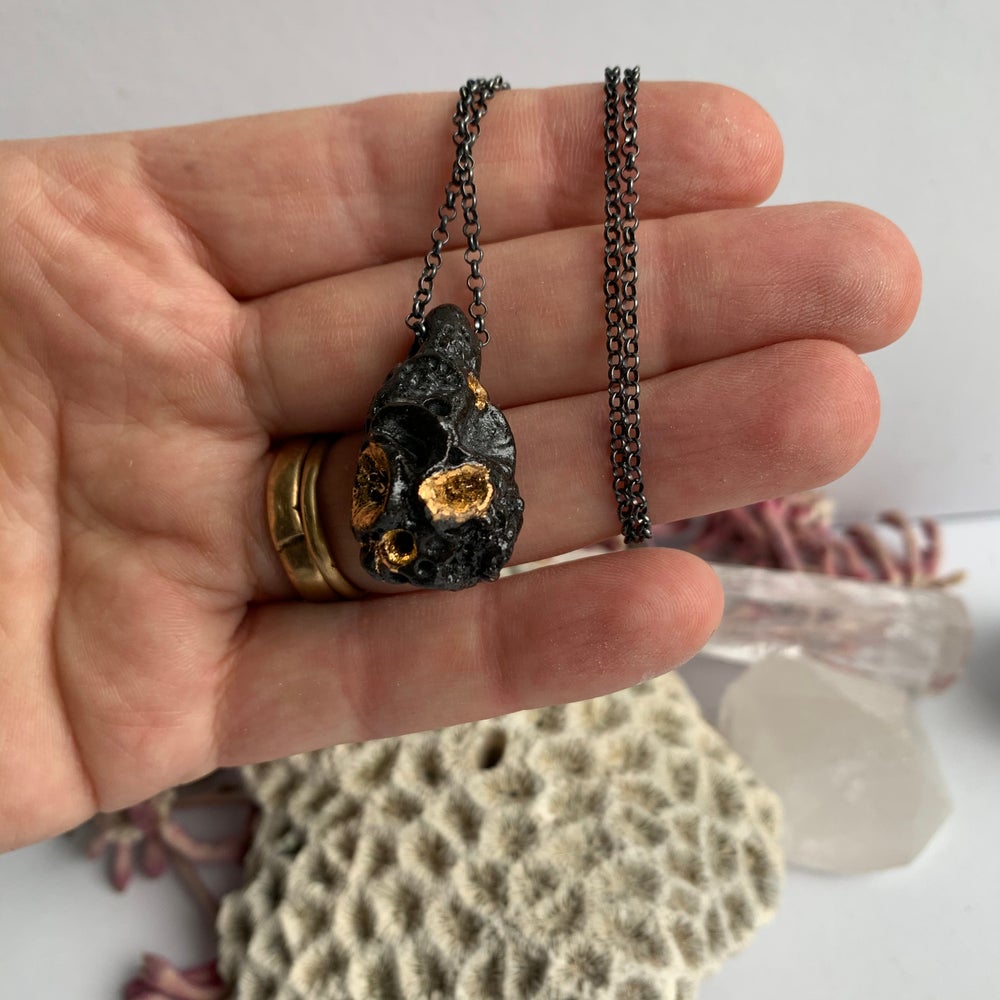 Black ‘rock coral’ pod pendant on oxidised sterling silver chain.
