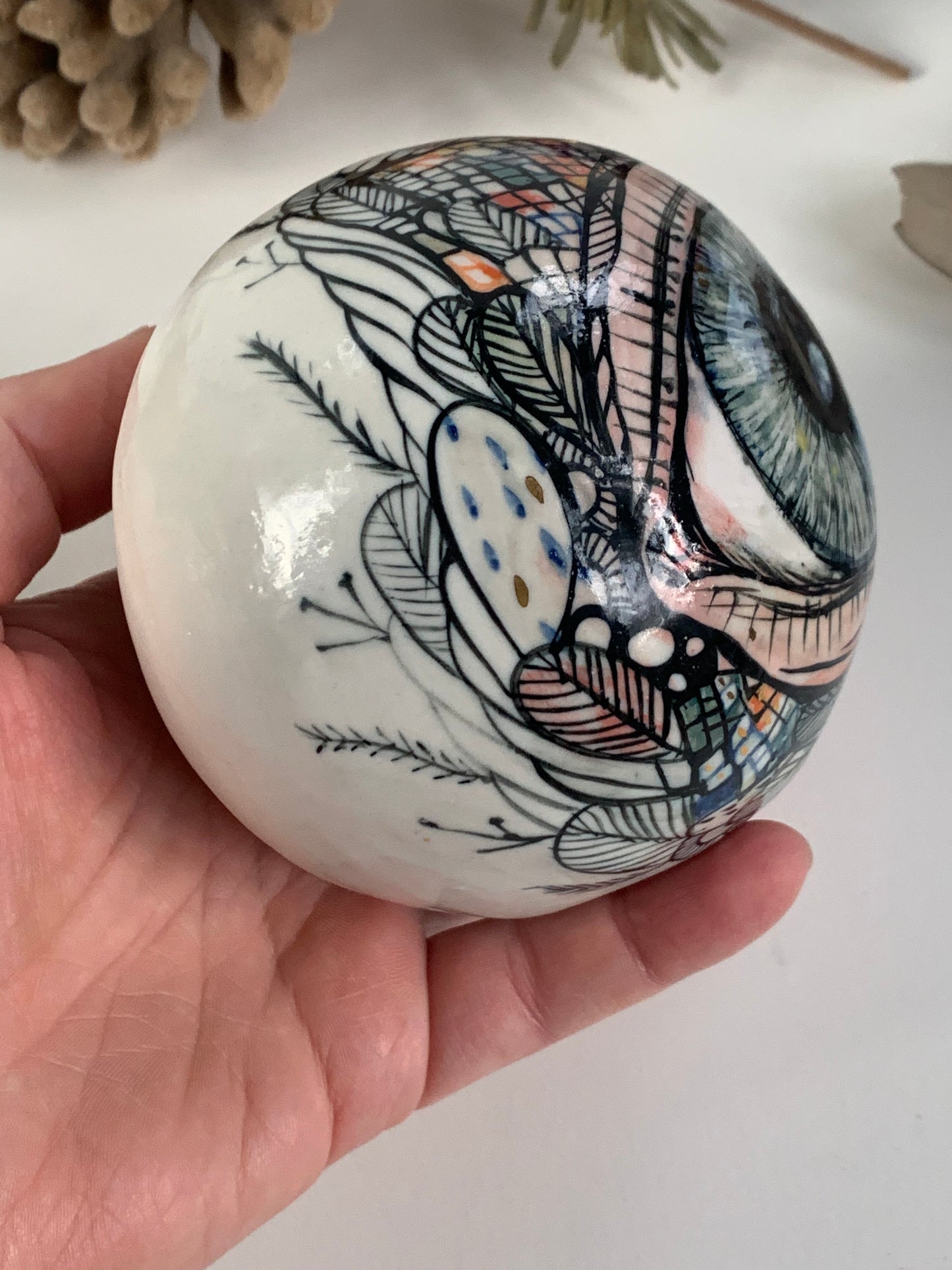 Hand  painted porcelain paperweight with gold lustre details