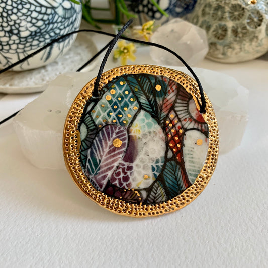 Hand painted porcelain pendant with gold border