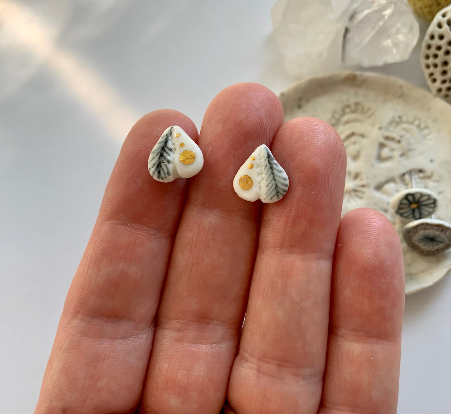 One pair of porcelain studs, blues