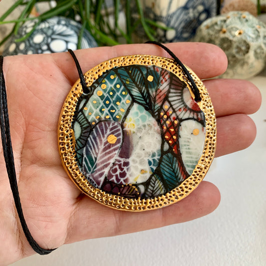 Hand painted porcelain pendant with gold border