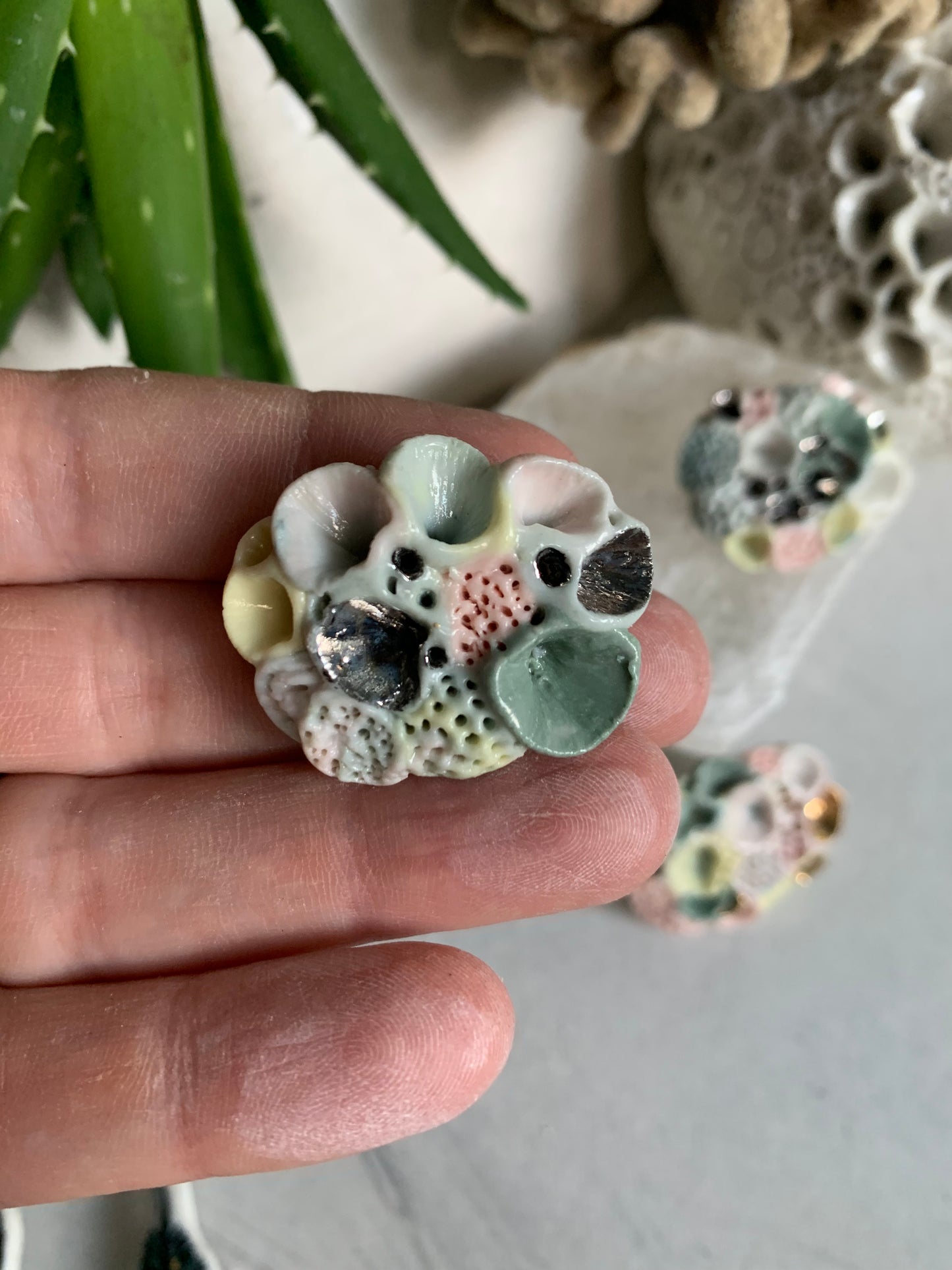 Copy o’Rock coral’ coloured porcelain brooch, choose one